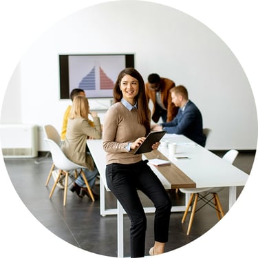 A female analyst at an organization that went through an AI Strategy Enablement holds a tablet in her hand and feels empowered by the broad AI applications she has access to, such as Salesforce AI, to get a lot of work done.